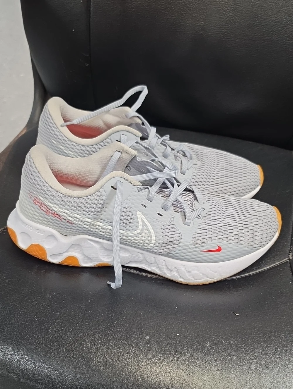 Nike Women's Light Gray Athletic Sneakers with Orange and Red Accents